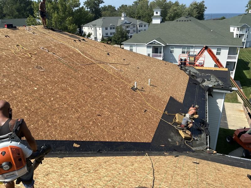 Crew installing roof decking on an apartment building